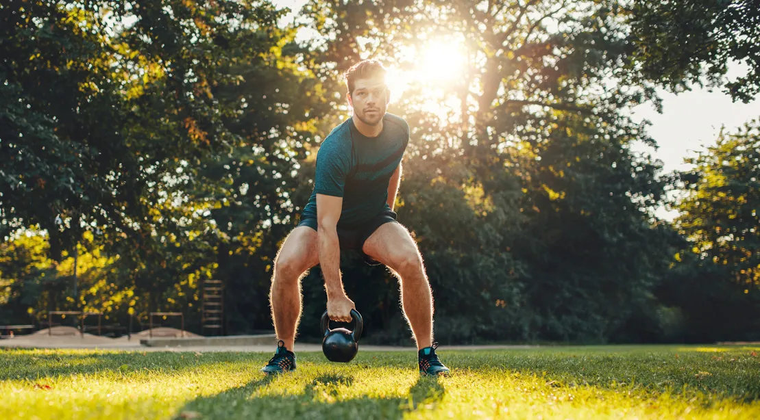 Athlete resting between sets on a training bench